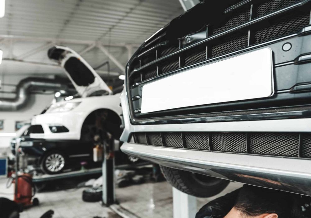 Car raised on car lift in car service shop